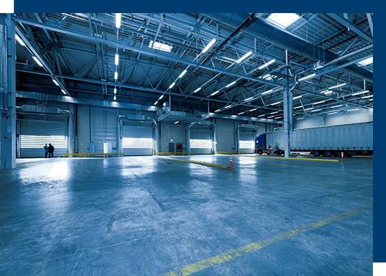 A large warehouse with lots of windows and doors.